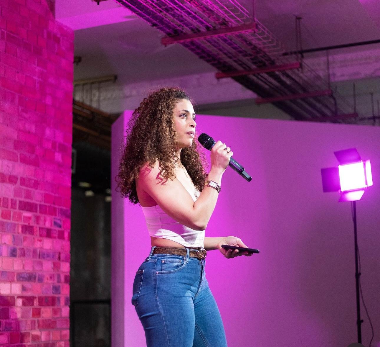 Woman in pink shirt standing against the railing